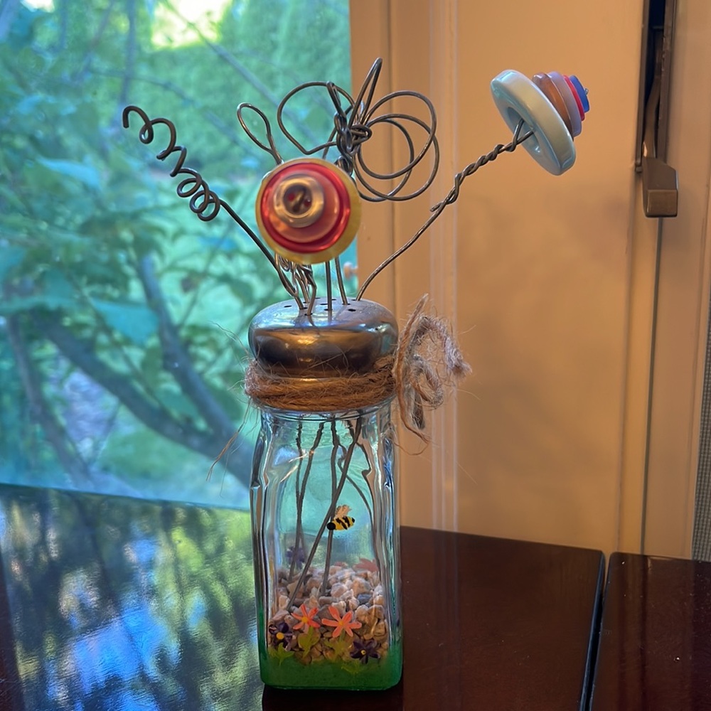 Whimsical vintage salt shaker and buttons flower arrangement